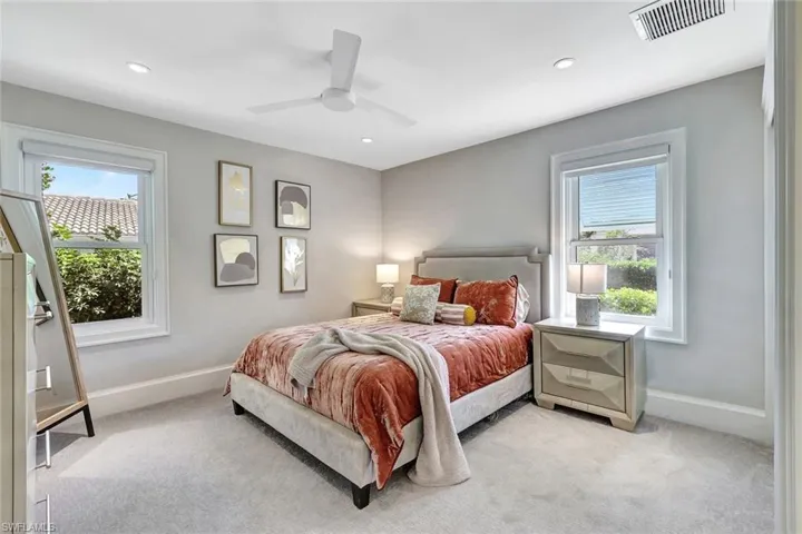 Carpeted bedroom with ceiling fan