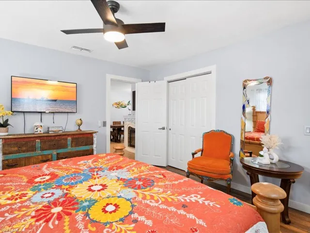 Bedroom featuring ceiling fan, wood finished floors, and a closet