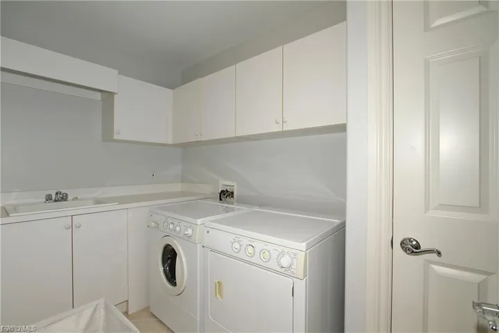 Laundry area featuring cabinet space and washer and dryer