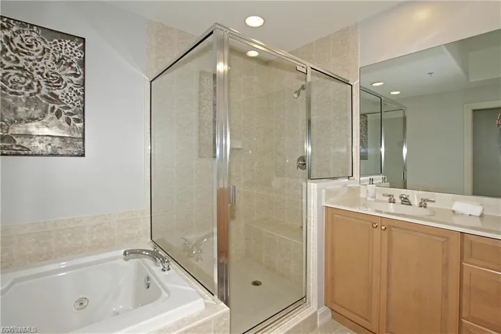 Full bath with vanity, a stall shower, a tub with jets, and recessed lighting