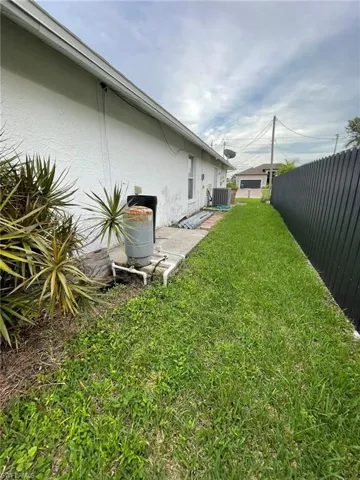 View of yard featuring a patio and central air condition unit