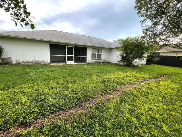 Back of house featuring a lawn