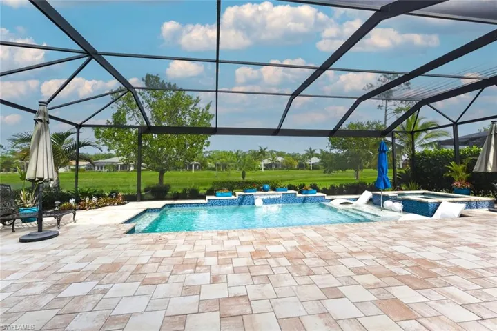 View of swimming pool featuring a sunroom, a lanai, a patio area, and a pool with connected hot tub