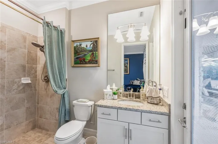 F#4 irst floor POOL Bathroom featuring ornamental molding, vanity, a stall shower, and ensuite bathroom