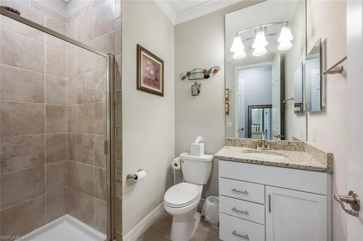 #3 Full bath featuring a shower stall, crown molding, and vanity