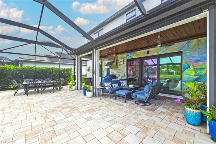 View of patio featuring a ceiling fan, a lanai, a sunroom, outdoor lounge area, and outdoor dining area