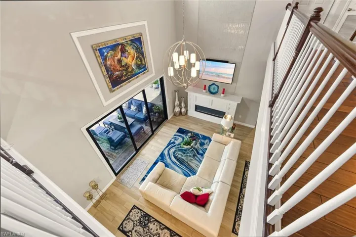 View from 2nd floor Living room featuring wood finished floors and a chandelier