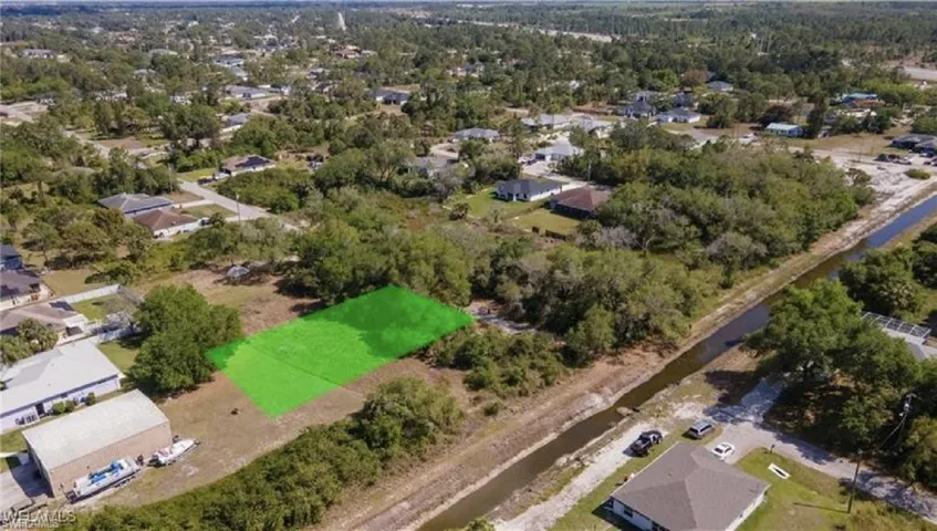 Aerial view of property's location featuring nearby suburban area