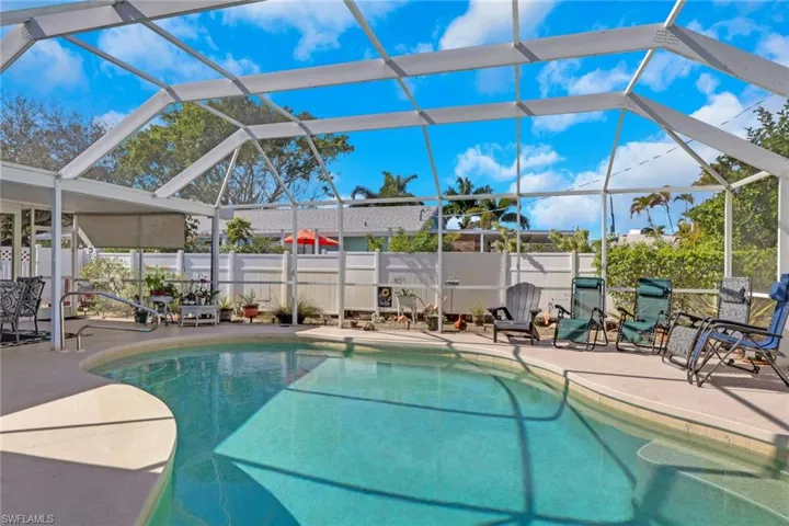 Heated pool with screen enclosure, outside dining area to the left; ample patio space