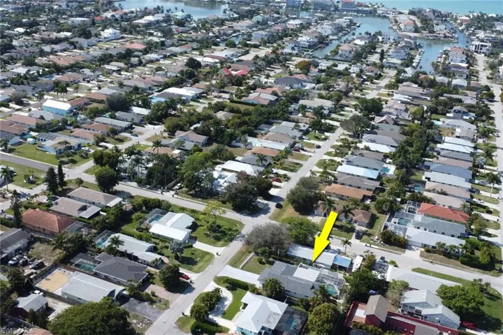 Aerial view of property and surrounding area with nearby suburban area