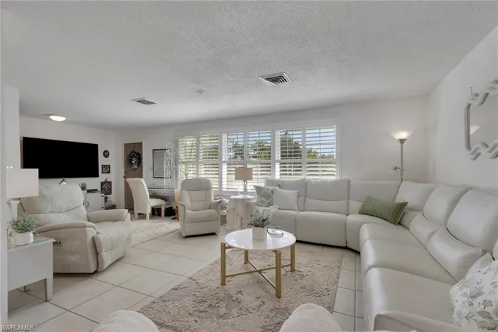 Tiled living area with plantation shutters