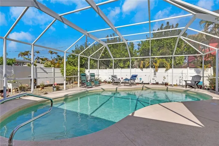 Heated pool with ample space around for lounge chairs and sunbathing; fenced in yard