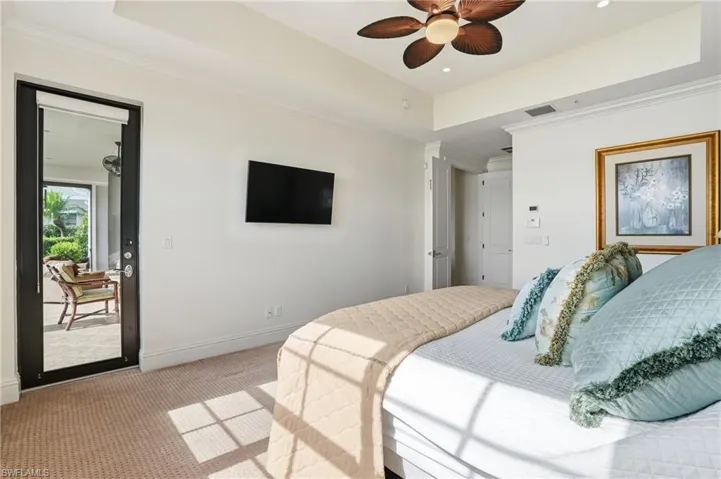 Carpeted bedroom with a raised ceiling, a ceiling fan, crown molding, access to outside, and recessed lighting