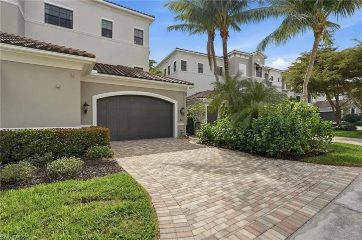 Mediterranean / spanish home featuring stucco siding, decorative driveway, and a tile roof