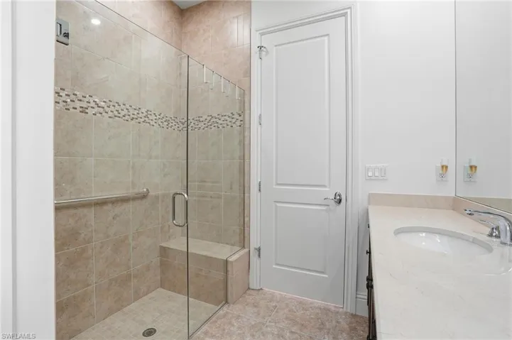 Bathroom featuring a stall shower and vanity