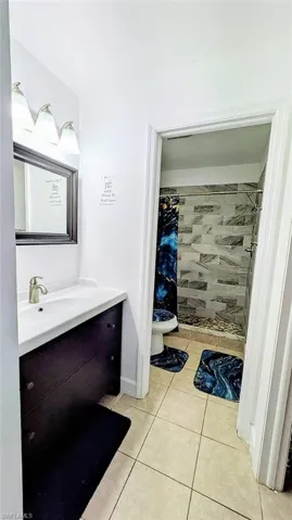 Bathroom with a stall shower, vanity, and light tile patterned floors