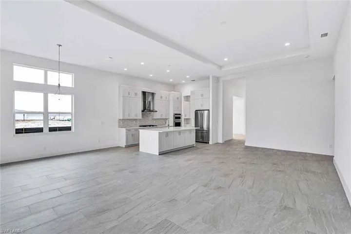 Upgraded kitchen layout accompanied with quartz countertops, soft-close cabinetry, and stainless steel appliances