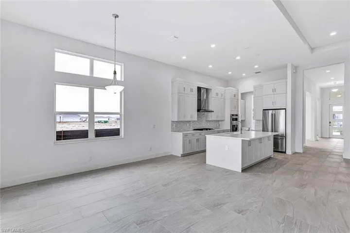 Upgraded kitchen layout accompanied with quartz countertops, soft-close cabinetry, and stainless steel appliances