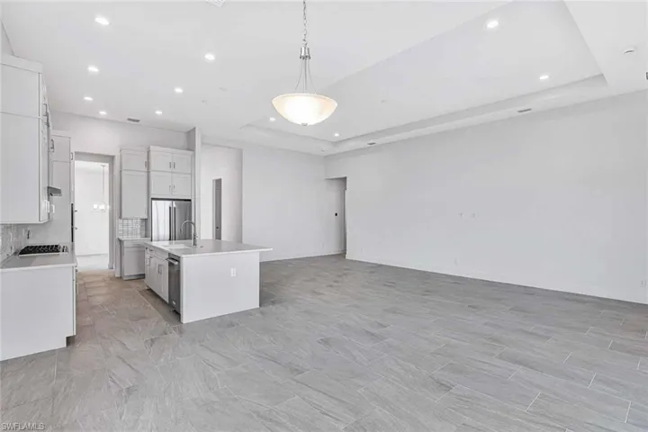 Upgraded kitchen layout accompanied with quartz countertops, soft-close cabinetry, and stainless steel appliances