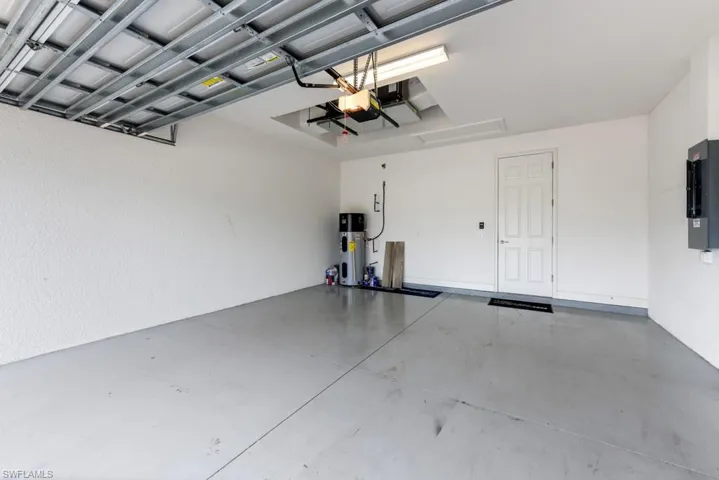 Garage with water heater and electric panel