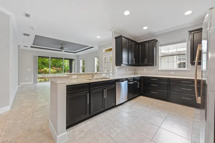 Kitchen with dishwasher, crown molding, kitchen peninsula, and ceiling fan