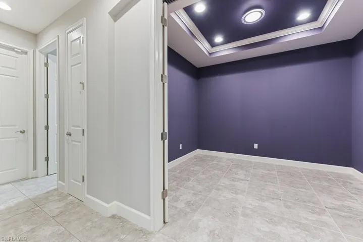 Empty room featuring crown molding and a raised ceiling