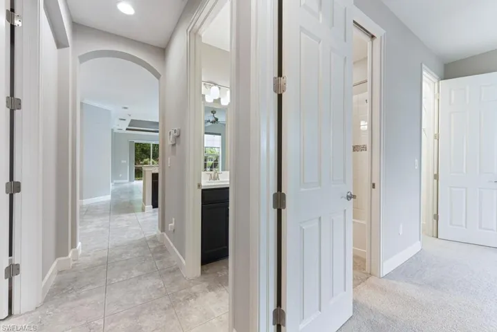 Hall with sink and light tile patterned floors
