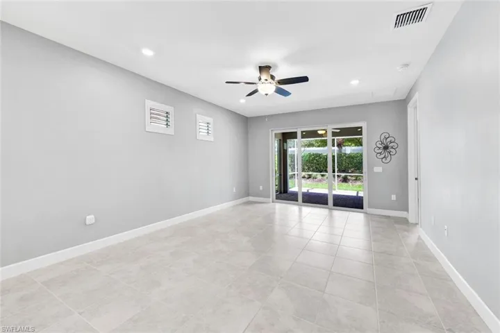 Empty room featuring light tile patterned floors and ceiling fan