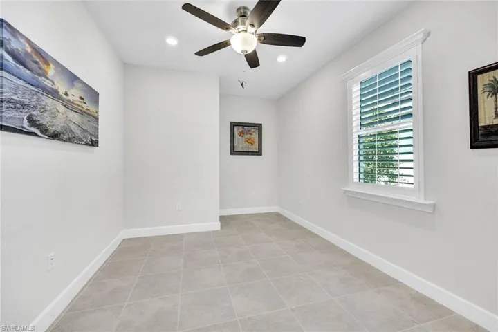 Tiled empty room with ceiling fan