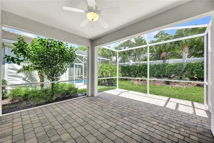 Unfurnished sunroom with ceiling fan