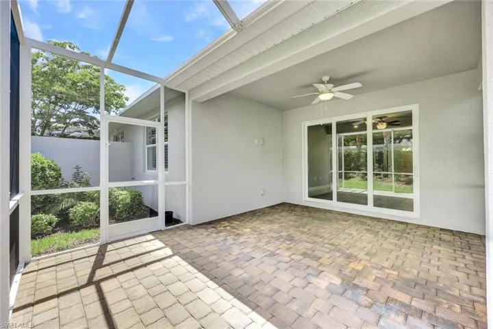 Unfurnished sunroom with ceiling fan