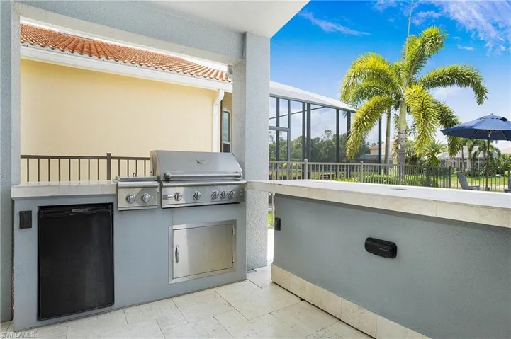 View of patio / terrace with area for grilling and a sunroom