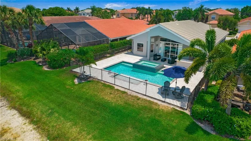 View of swimming pool featuring an in ground hot tub, a patio area, and a lawn