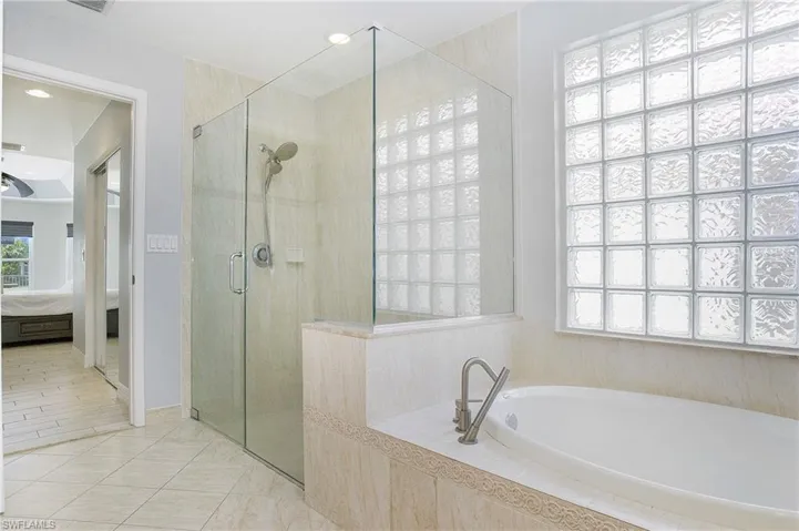 Master bathroom featuring tile patterned floors and separate shower and tub