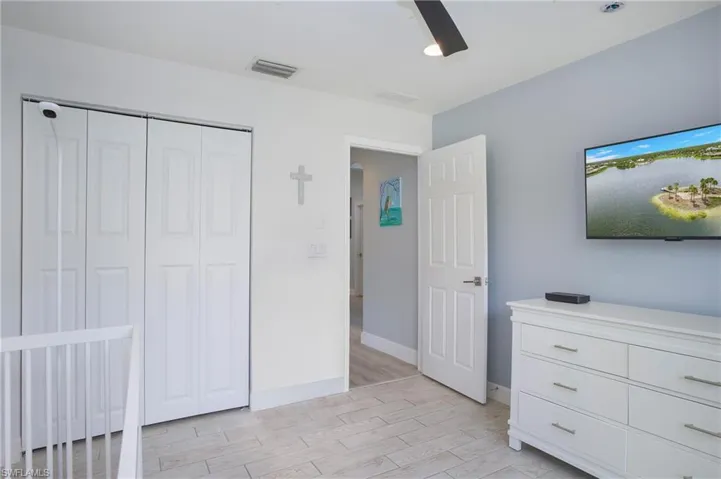 bedroom featuring ceiling fan, a closet, and light hardwood / wood-style flooring
