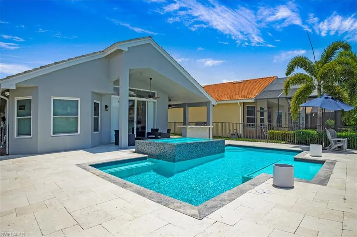 View of swimming pool featuring an in ground hot tub, a patio, and ceiling fan