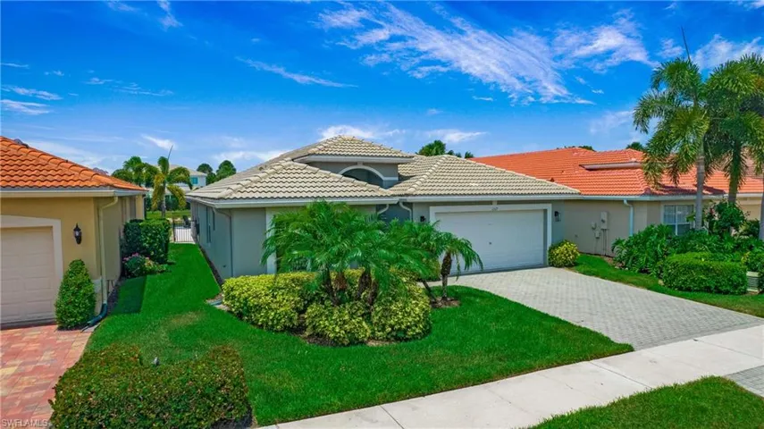 Mediterranean / spanish-style home featuring a front yard and a garage