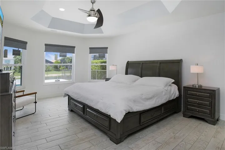 Bedroom with a tray ceiling and ceiling fan
