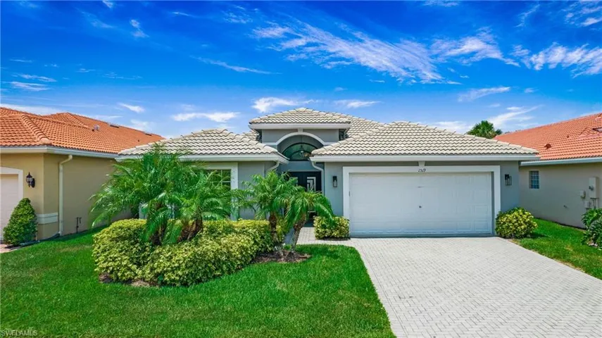 Mediterranean / spanish-style house featuring a front yard and a garage