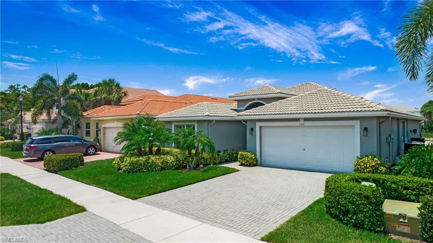 Mediterranean / spanish-style home with a front yard and a garage