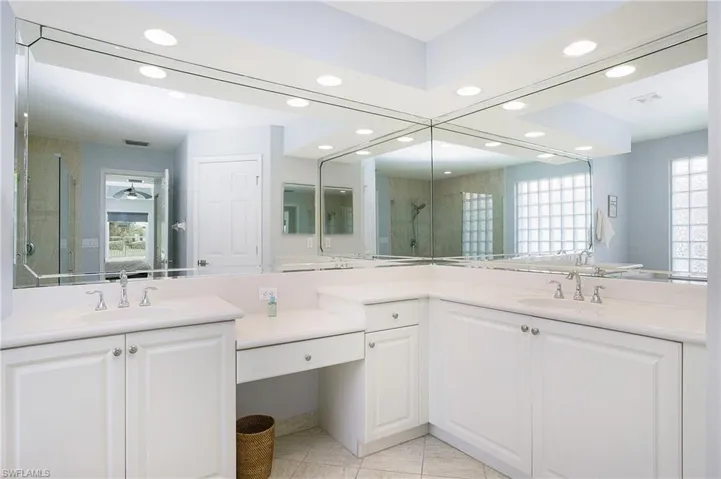 Master bathroom featuring vanity, tile patterned floors, and an enclosed shower