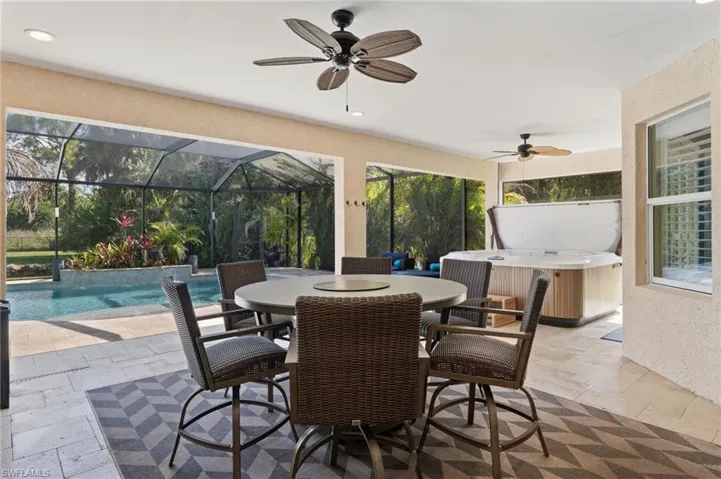 Plenty of covered lanai space, with seating area and hot tub.