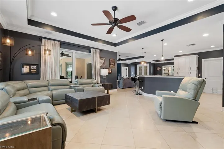 Open great room with coffered ceiling, breakfast bar, access to lanail.