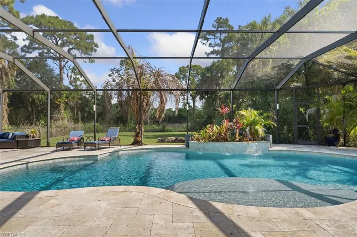 Custom pool with sunshelf and water feature.