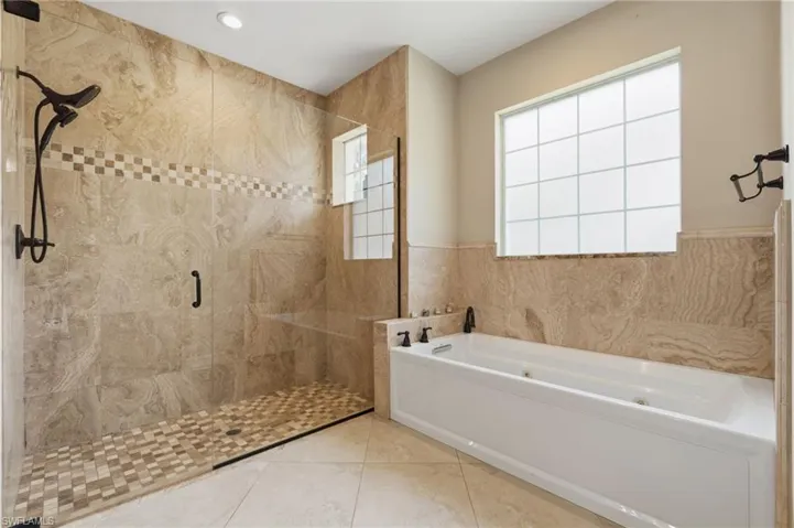 Spacious master bathroom with large walk in shower and separate tub
