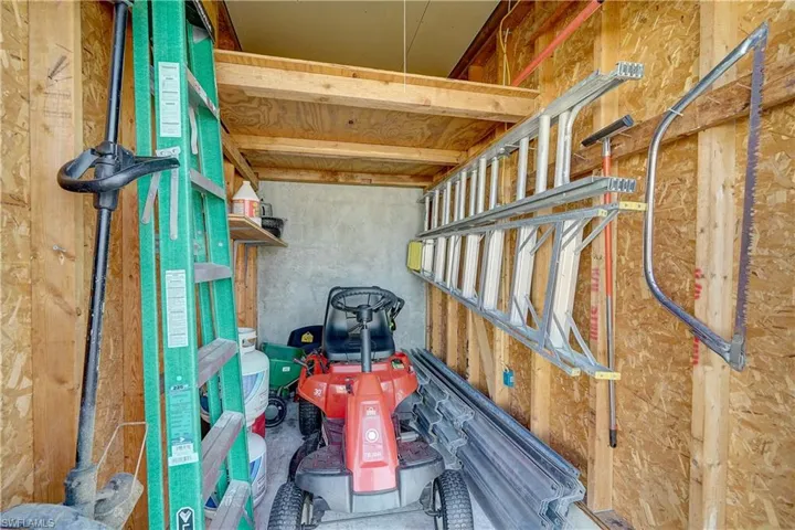 A "hidden" mower/lawn maintenance storage shed is built right into the house. a 10' x 5' area with high ceilings
