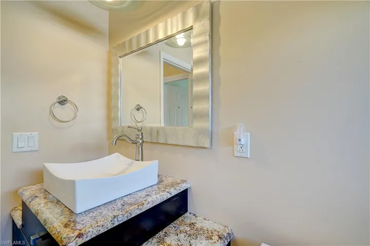 The impressive guest bathroom with very unique multi level granite countertops