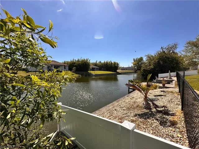 Property view of water featuring fence