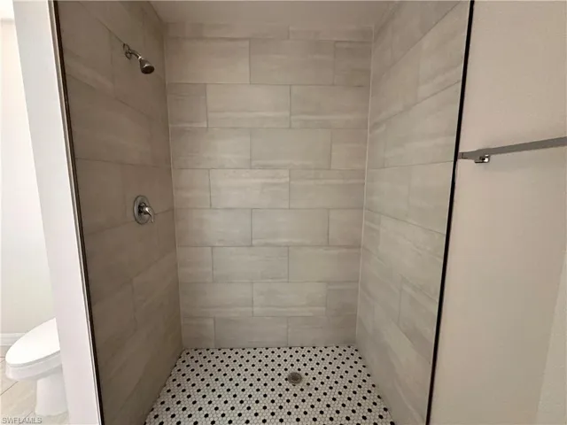 Bathroom featuring toilet and tiled shower
