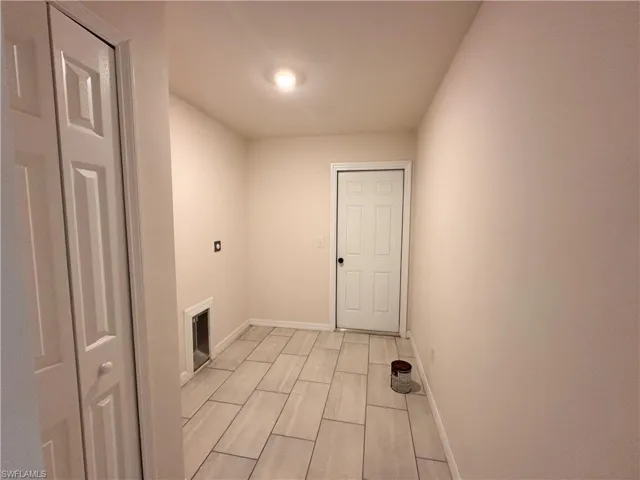 Washroom featuring baseboards and wood finish floors